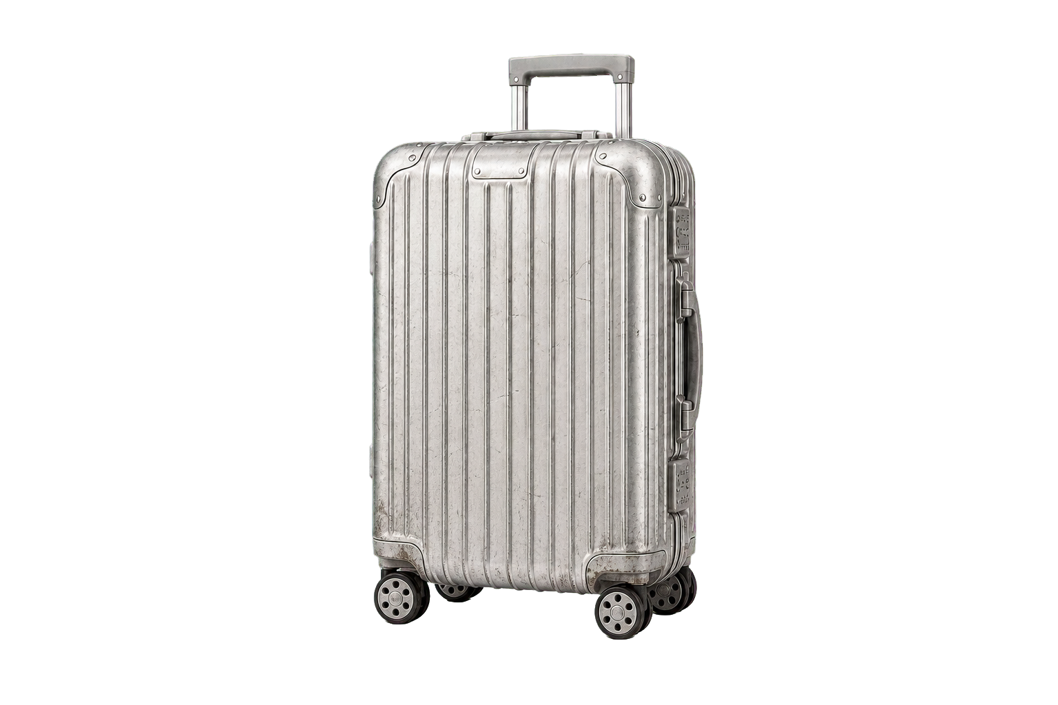 A well-traveled silver ribbed carry-on with scratches, scuffs, dents, and worn wheels